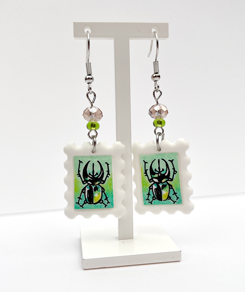 Horned Atlas | Polymer clay postal stamp earrings